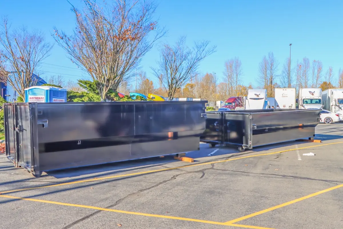 Professional dumpster rental service with roll-off container on residential driveway in Waxahachie